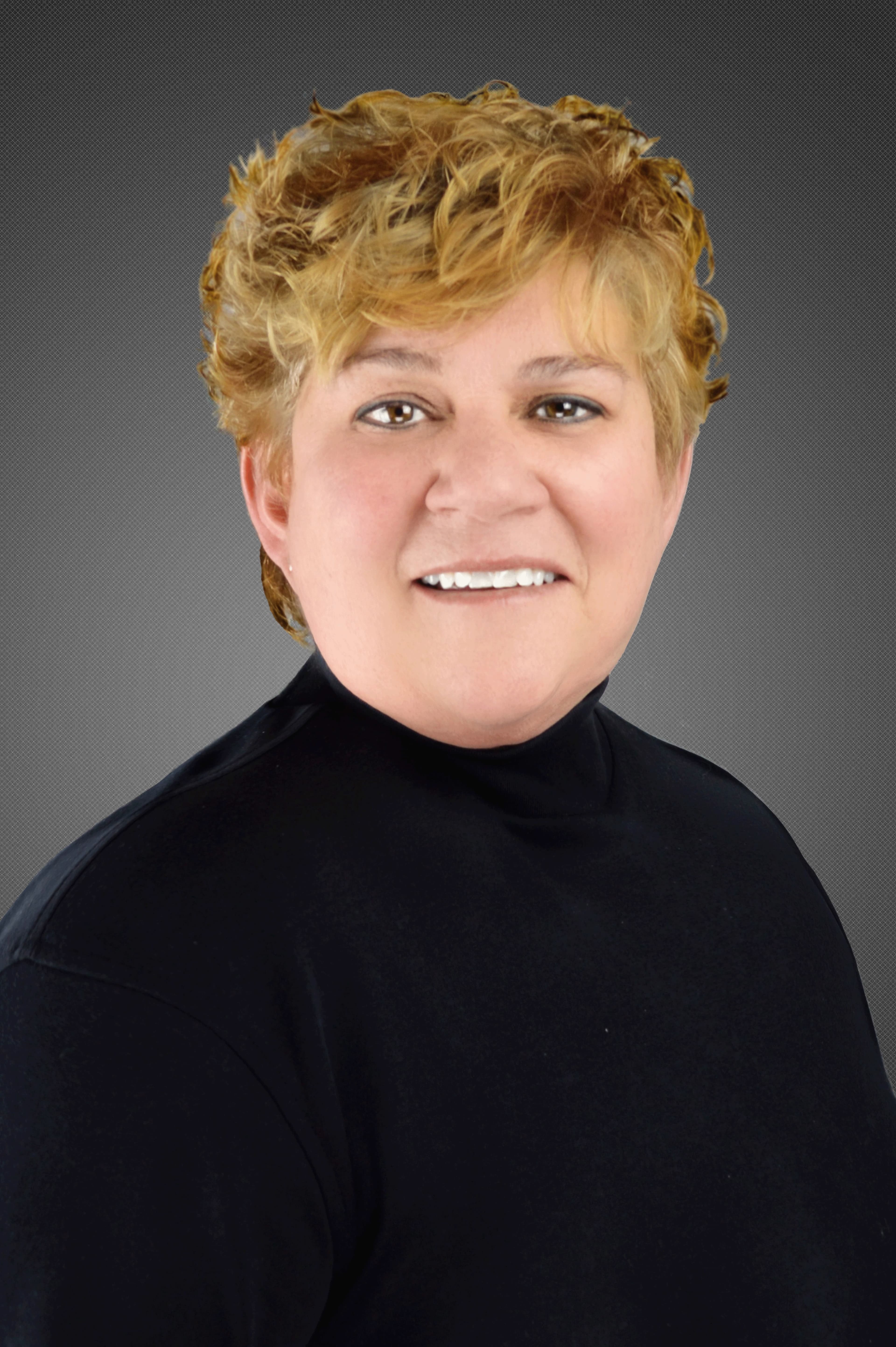 Smiling woman with short curly blonde hair wearing a black turtleneck against a gray background.